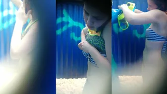 Young Girl Distracted by Phone in Beach Changing Room